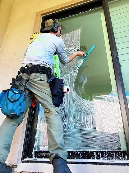 Professional window cleaner at work